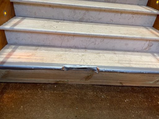 Cream marble step cracked.