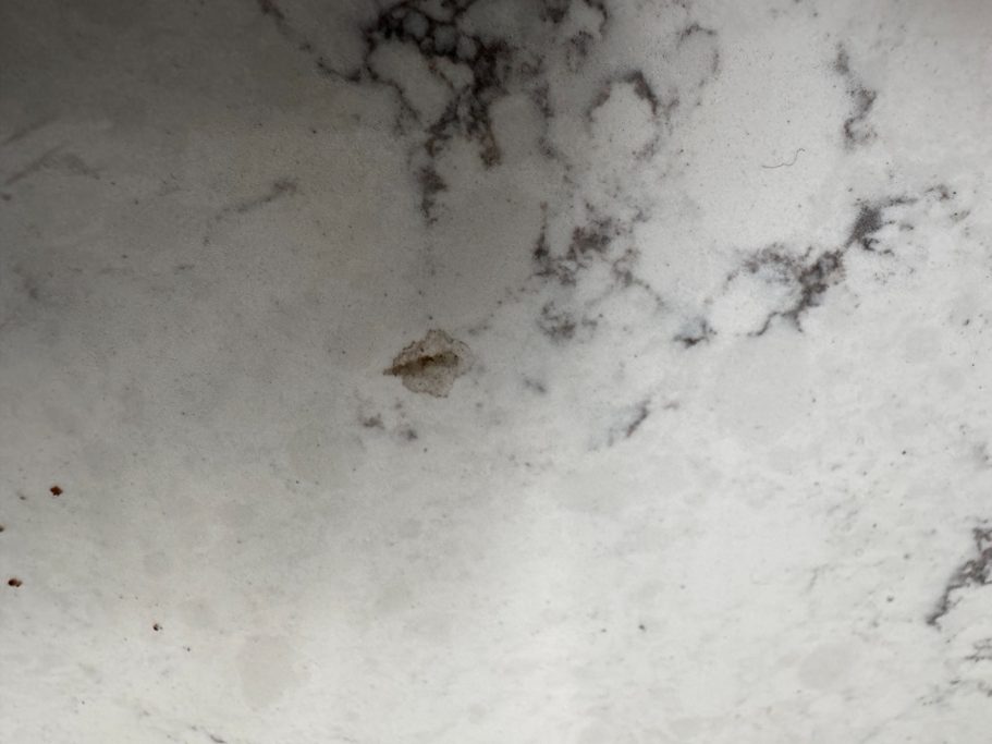 Big chip out of quartz worktop. carrera white quartz worktop in harrogate chipped worktop on the surface.