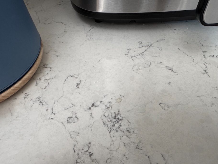 Picture of quartz worktop in white with the finished repair. Finished worktop repair to the surface. Filled and sanded with a special mix of resins.