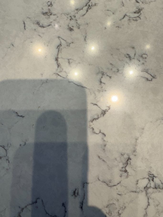 After repair: filled chip in white quartz White quartz surface after the chip was filled and finished to blend with the surrounding surface.
