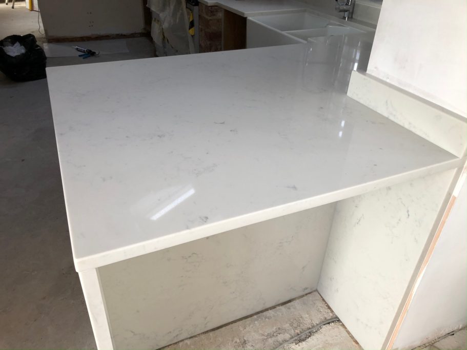 White breakfast bar worktop Carrera White Marble repaired and repolished in otley west yorkshire.