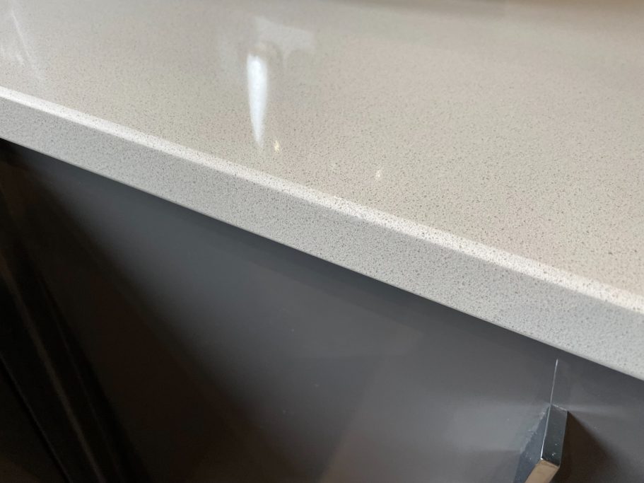 After repair: filled and polished quartz edge Re filled and polished kitchen quartz worktop edge.