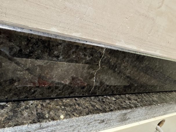 Before: cracked granite upstand Cracked Ubatuba granite rear upstand before repair in Hebden Bridge.