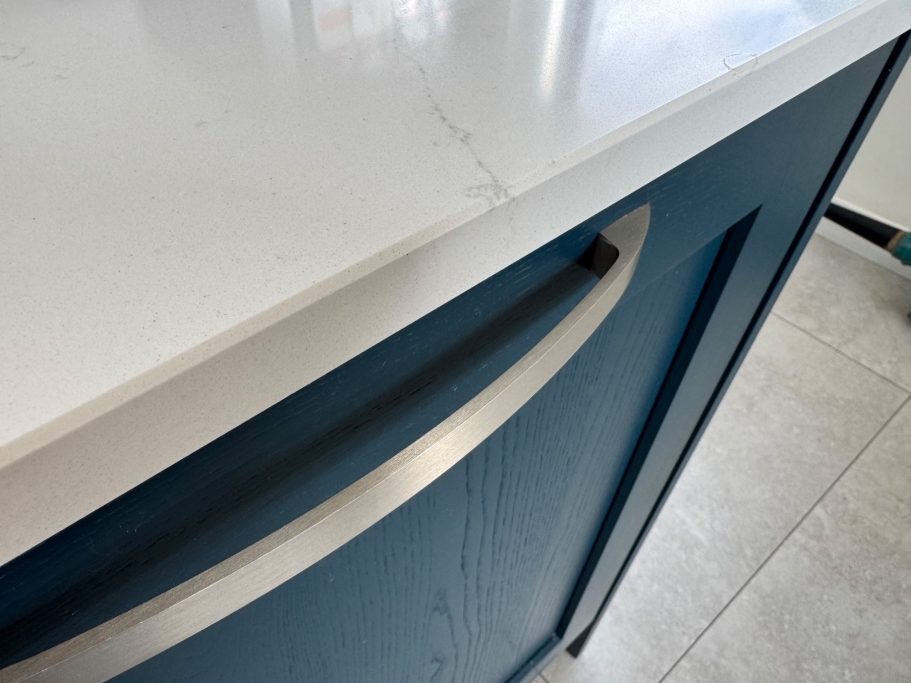 Finish repair to the white quartz kitchen worktop. Repair of a white quartz worktop in Sheffield, demonstrating the completed restoration of damage at the edge.