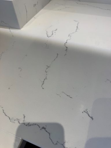 Carrera White marble effect kitchen worktop fully restored. Scratches were removed and the hole filled. This finished worktop repair in Leeds was filled with resin and re-polished to match the existing finish which was a high gloss marble.