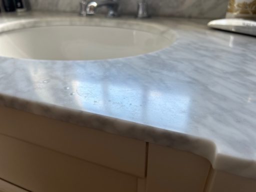 White marble bathroom top with misty marks and stains. Marble bathroom vanity top stained because of wrong cleaning.