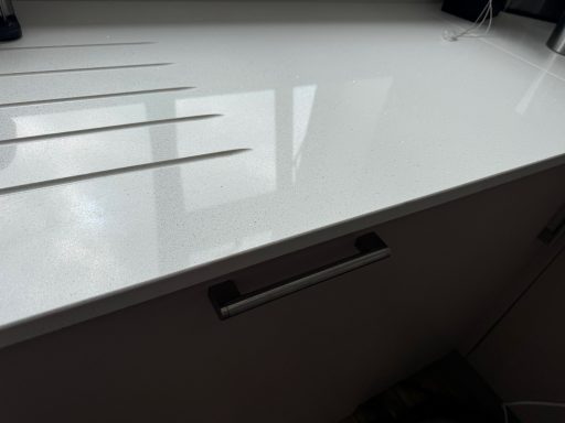 Quartz worktop at the draining groove area.  Picture showing repaired worktop at the edge of the quartz due to accidental damage.