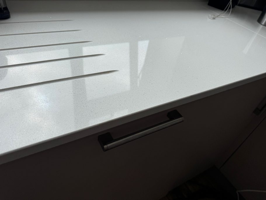 After repair: quartz edge beside draining grooves Quartz worktop at the draining groove area. Picture showing repaired worktop at the edge of the quartz due to accidental damage.