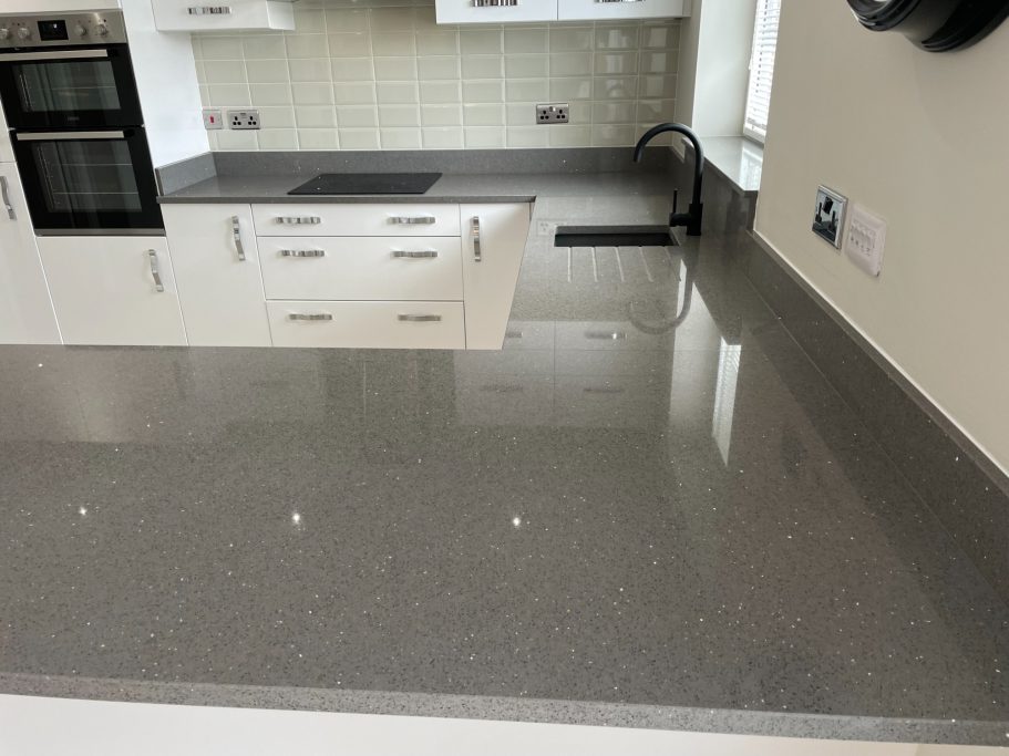 After restoration: polished grey quartz kitchen with grey quartz worktop