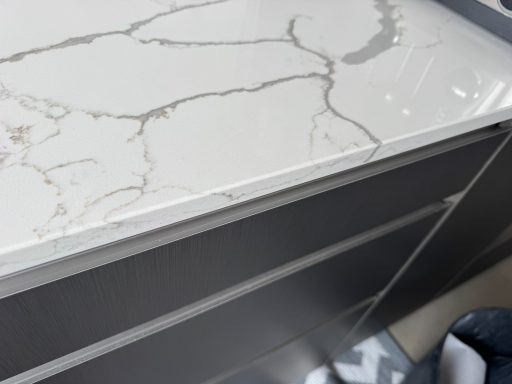 Fully repaired quartz worktop, this involves repairing the edge. Picture of a white quartz worktop all finished and repaired, the edge was refilled with a resin and polished and shaped.