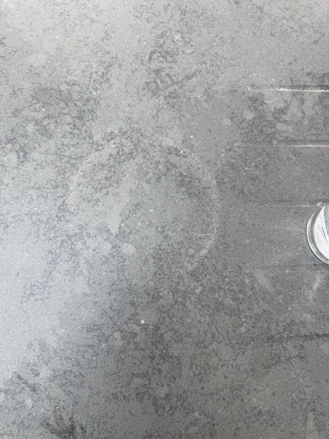Close-up of the granite surface mark "Picture showing a circle mark on the granite worktop surface."