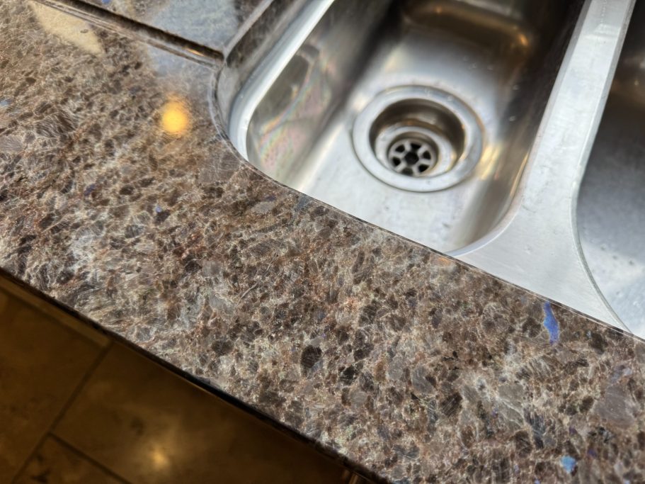 After repair: restored granite sink run Granite worktop in huddersfield with reaired crack at the front. This granite had to be filled and sanded to match existing surface.