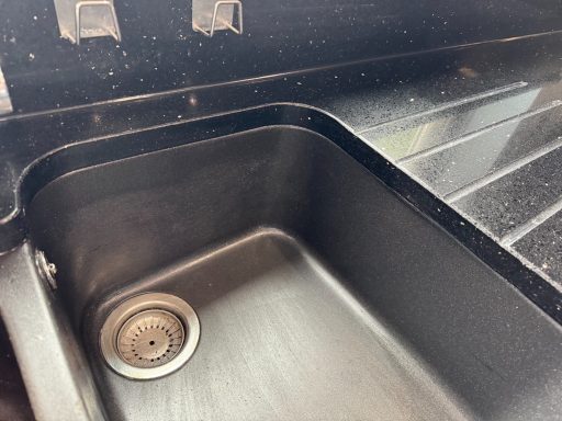 Black granite worktop, fully restored and polished Finished restored kitchen worktop showing the Joint to the underside of the sink completely renewed.