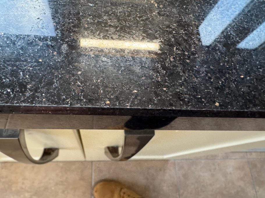 After repair: restored black granite edge Repaired edge on granite worktop.