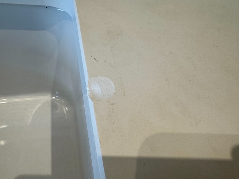 Before repair: impact damage to a white worktop impact damage to a white worktop