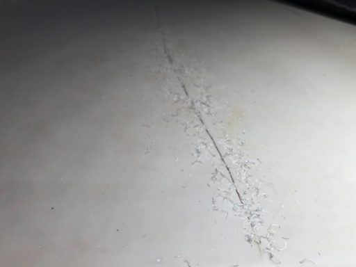 Discoloured corian worktop. Corian cracked on the surface , needs filling and sanding, Job repaired to a high standard and could not tell. 