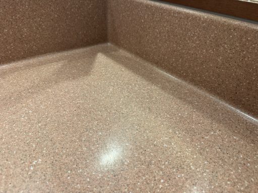 Close-up of a smooth, pinkish-brown surface with a subtle sheen. worktop repair in huddersfield.