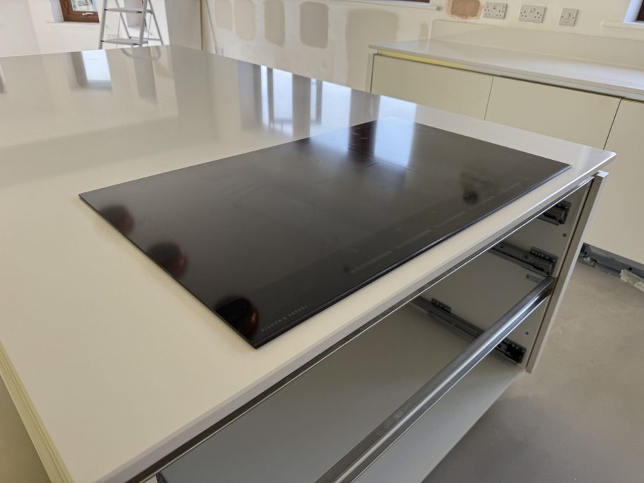 Finished result: induction hob fitted in Mirfield Finished induction hob fitted into the altered pure white quartz worktop opening in Mirfield.