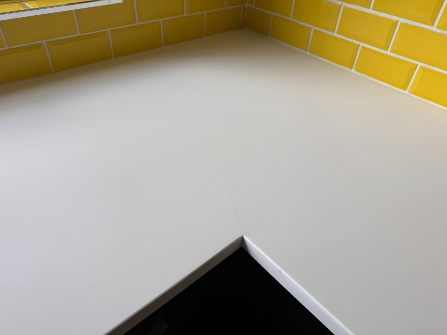 Restored white Corian worktop corian scratched and cracked worktop at the edge and the surface