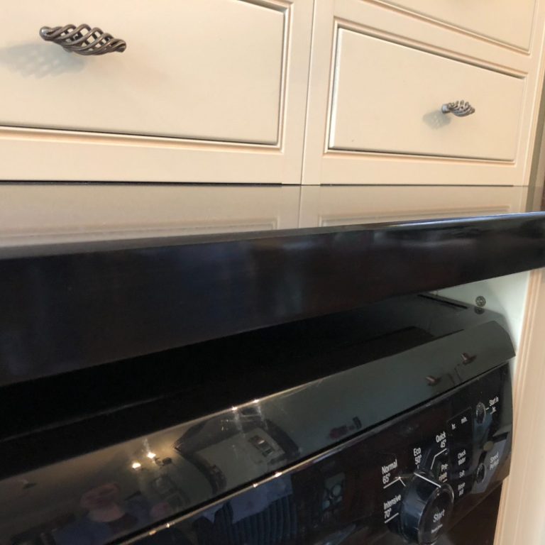 Close-up of a repolished edge.30mm jet black granite called nero absalout.