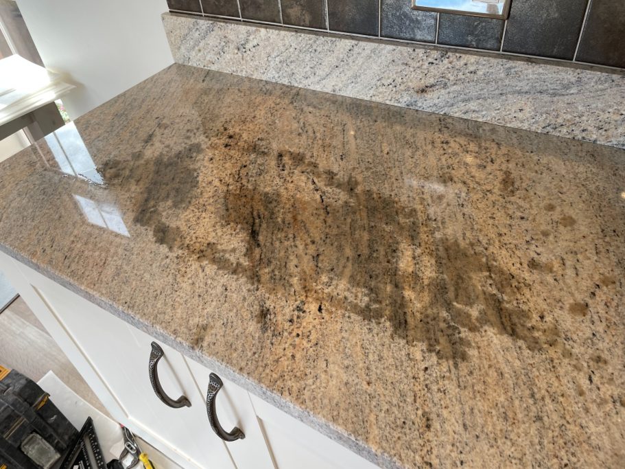 Before treatment: oil stain on granite Granite top stained with hot oil. Granite was very porous , no sealer on the surface to repel. Stained granite worktop in huddersfield.