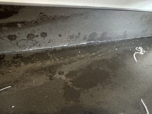 Before: gap below upstand Gap and old adhesive between the dropped Dekton worktop and rear upstand before re-levelling in Dodworth, Barnsley.
