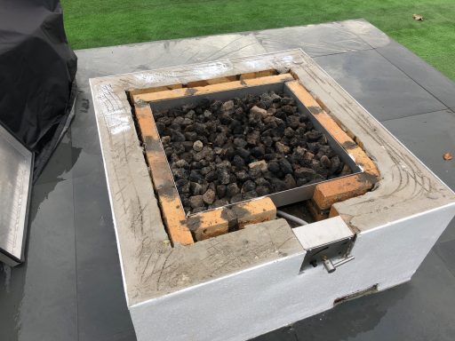 Marble fire pit outside to match outside barbecue. Concrete base of a fire pit which required a top made of granite, which was more durable than quartz, this gets really hot.