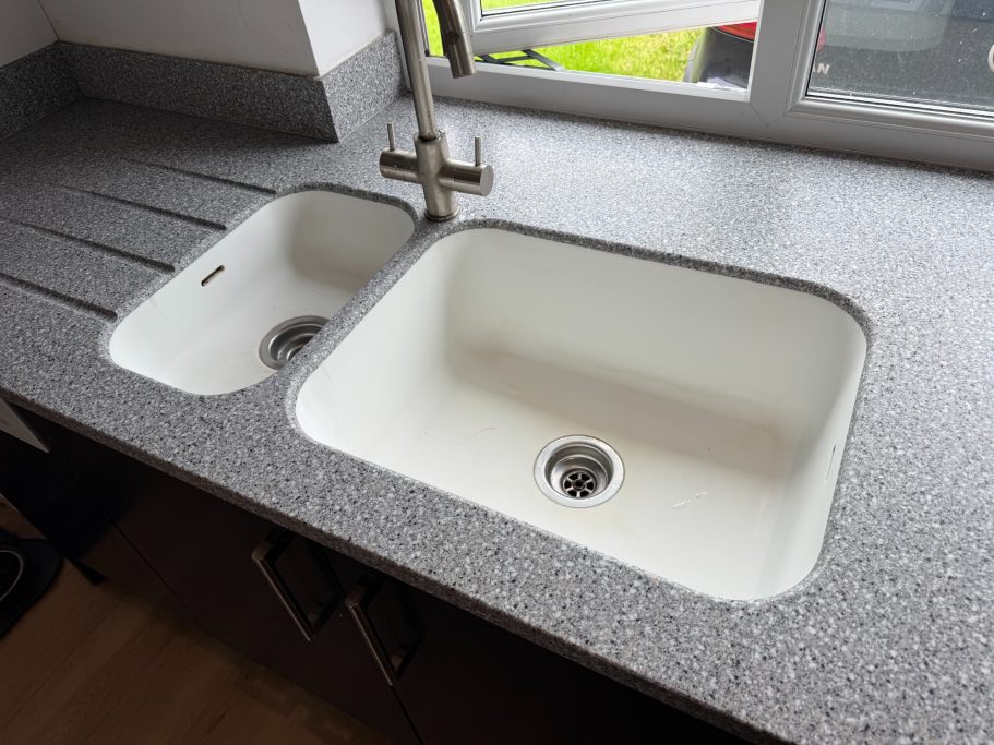 After restoration: refinished Corian sinks White corian bowl and a half sink fully restored. The insides were repolished to match the finish on the corian worktop.