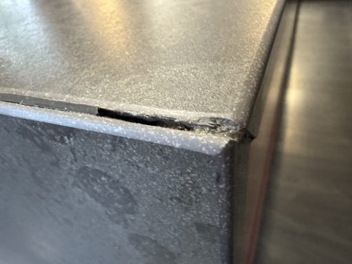 Before: damaged Dekton corner Damaged Dekton worktop end corner before repair in Dodworth, Barnsley.