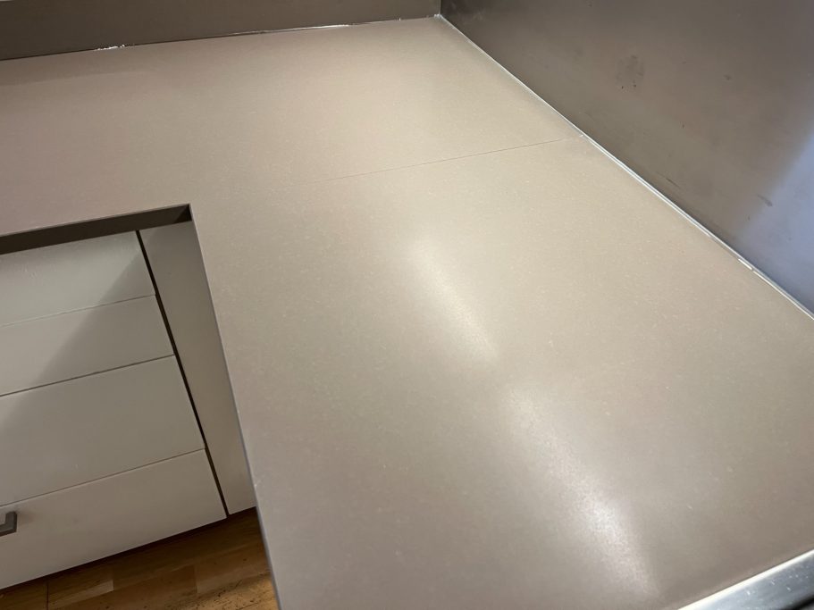 After restoration: repolished quartz surface Light brown quartz worktop in a customers kitchen. Picture showing a full re-furbishment surface to the quartz top, removing the mark.