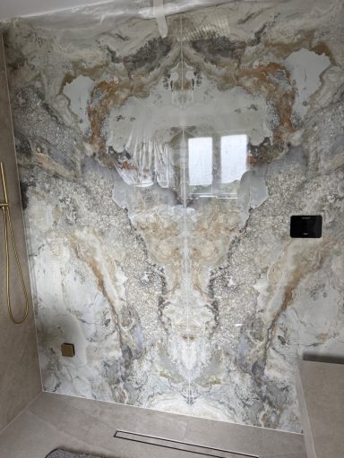 Marble effect wall panel in a bathroom on the main feature wall. Book match wall panel in marble from floor to ceiling the damage was at the bottom you can see this on pictures previous.