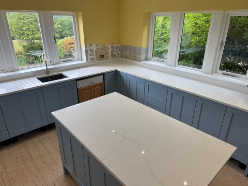 Carrera white quartz worktops  with large island bar showing walls exposed to stains. Job in Stockbridge, Huddersfield.