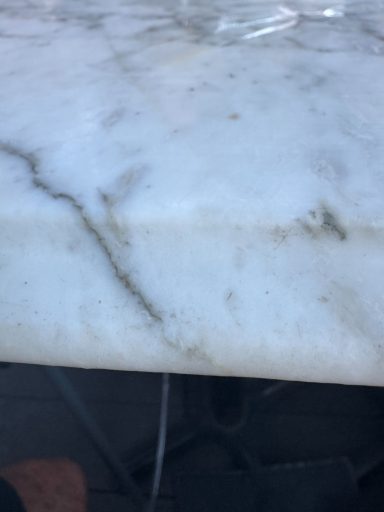 Picture showing the Repair of the Carrera White marble bathroom vanity top "White marble vanity top with the repair to the edge; the piece was put back in and fully restored."