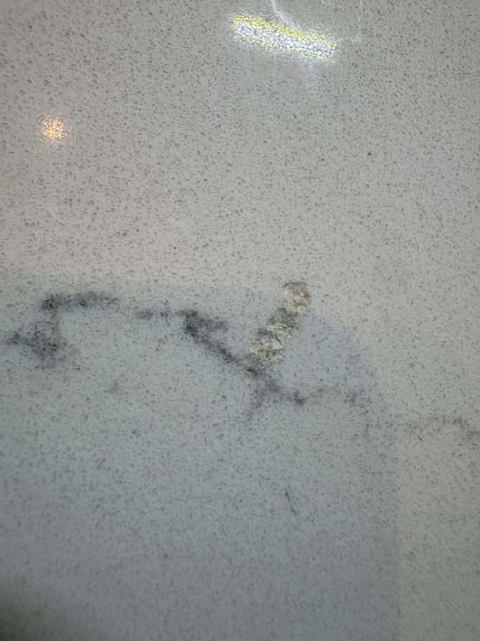 Before repair: impact damage to a white worktop in Leeds If you look close at this picture, you will see a damaged marble Carrera White worktop at the Grey vein, this had a wine bottle dropped on i