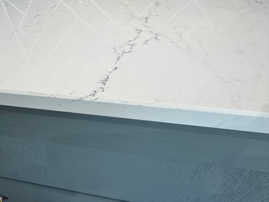 After repair: reshaped and polished quartz edge Close-up of quartz worktop repair on then edge and the surface, this had to be colour matched with resin.