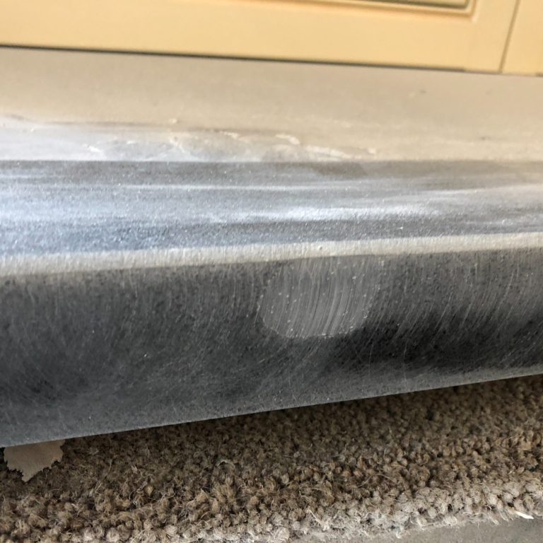 A close-up of a textured surface with scratches and dust.this has just been filled with a special resin.