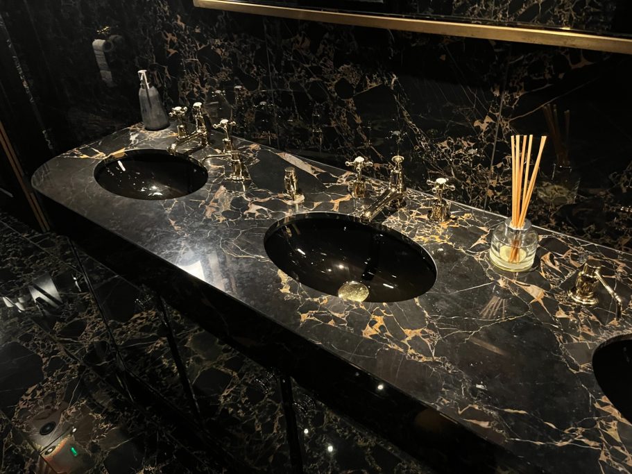 Black and gold granite vanity top Granite worktop repair in Leeds. Cosmic gold granite chipped on the edges and scratched on the surface.