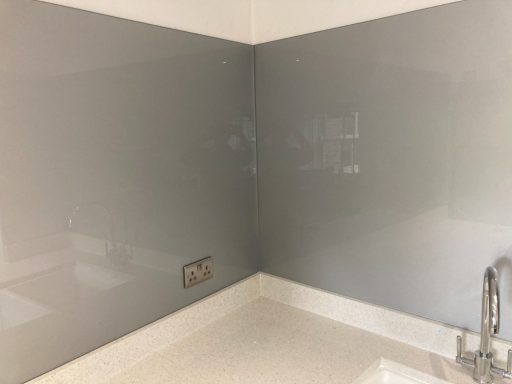 Full height glass splash back.  Grey glass was fitted onto the quartz upstand.