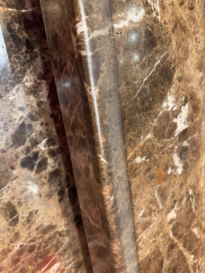 Polished brown marble Close-up of polished dark marble showcasing intricate patterns and textures.