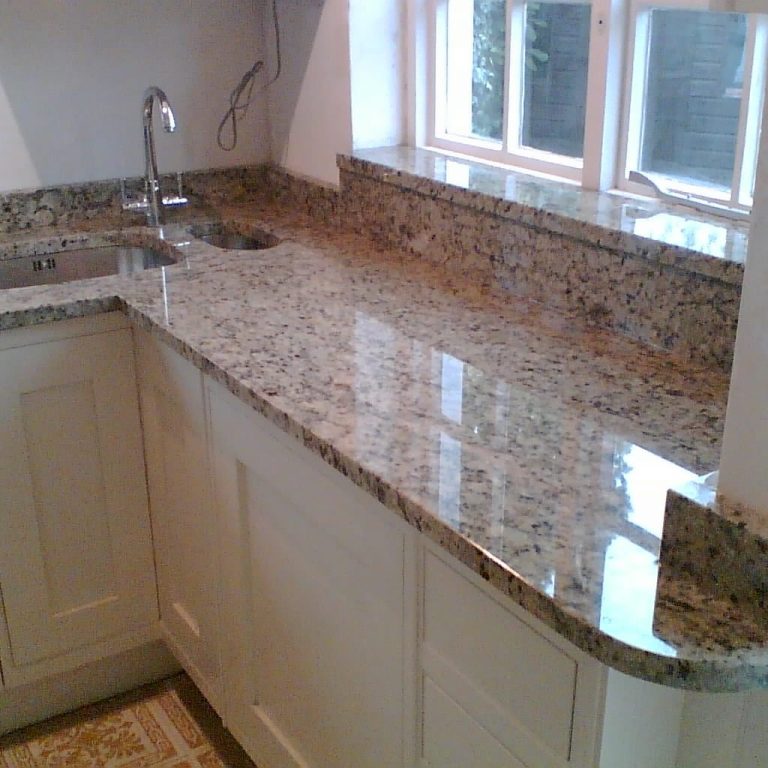 Gold granite with poished surface , buffed, resealed and cleaned.  Chipped on corner also repaired.