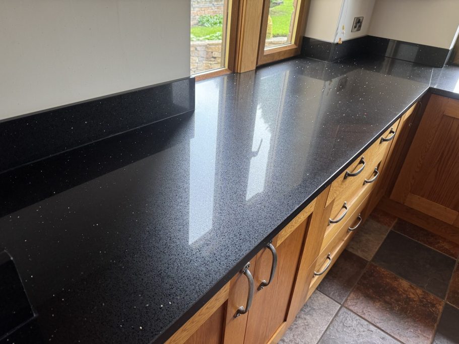After: restored quartz shine Black quartz worktop in Highburton, Huddersfield after re-sanding and polishing to restore the shine.