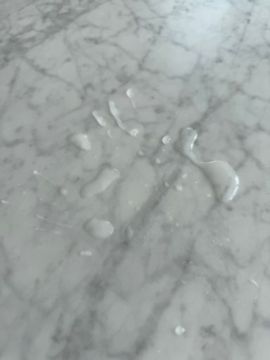 Carrera white table top, showing a repelant put on the surface to stop further staing. The marble table top kept on staining .