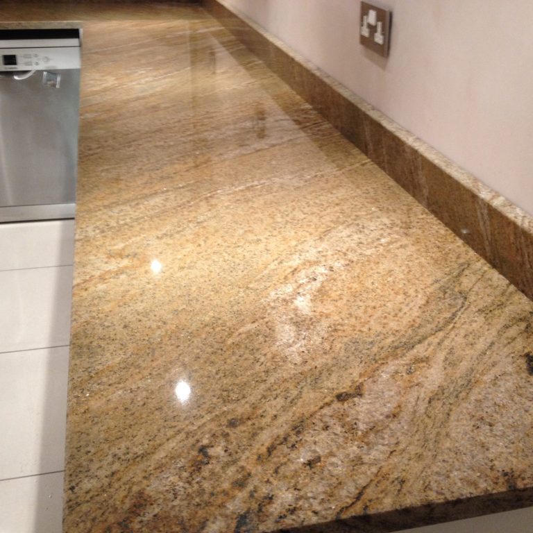 30mm granite worktop fitted in west yorkshire, picture showing long run of natural granite with upstand matching vein.