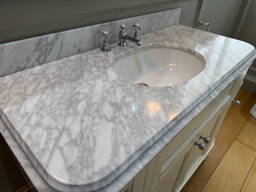 Repaired White marble bathroom top. Veined White marble with the surface polished to a high gloss.