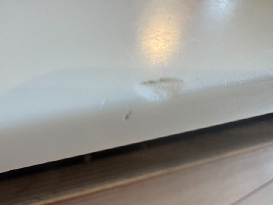 Before repair: damaged Corian edge and surface White corian worktop damaged on the edge also surface was partly damaged. This needed filling with the same material to match