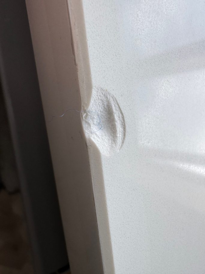 Close-up of damaged white quartz edge Close up of the white worktop made in quartz. This quartz top in huddersfield had a plate dropped on the surface causing the damage.