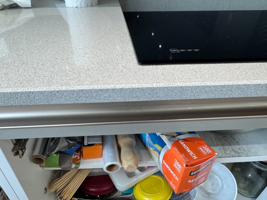 After repair: restored grey quartz edge The grey speckled quartz worktop in Leeds was filled and thoroughly sanded to align with the existing shape of the edge.