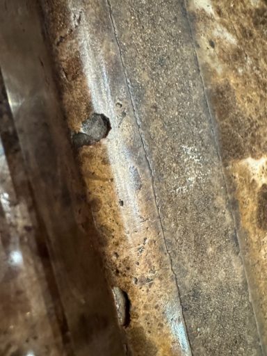 Textured, rusted surface with visible holes and wear.