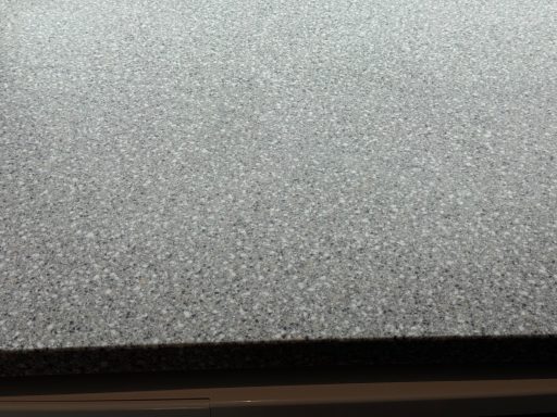 Repaired Corian worktop showing the surface and the edge fully restored. Picture showing a close-up of a Corian worksurface sanded to its original sheen. Look at the picture before the repair, look now at repair.