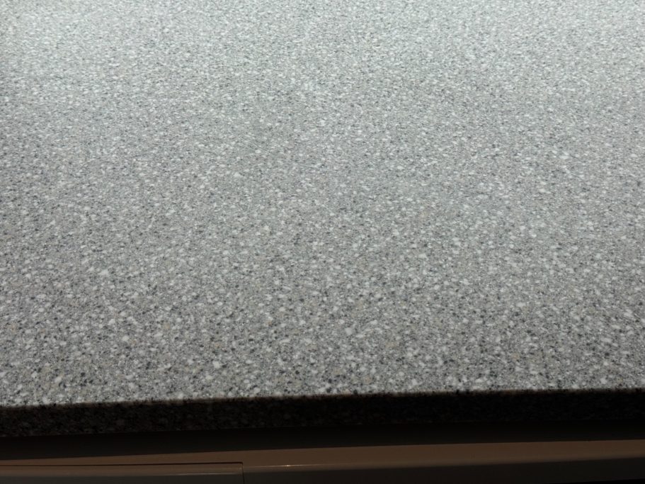 After repair: Corian surface and edge Picture showing a close-up of a Corian worksurface sanded to its original sheen. Look at the picture before the repair, look now at repair.